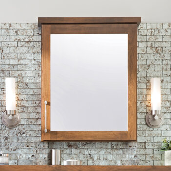 A medicine cabinet with a built-in vanity mirror on the door made to coordinate/match the vanity and other cabinets.